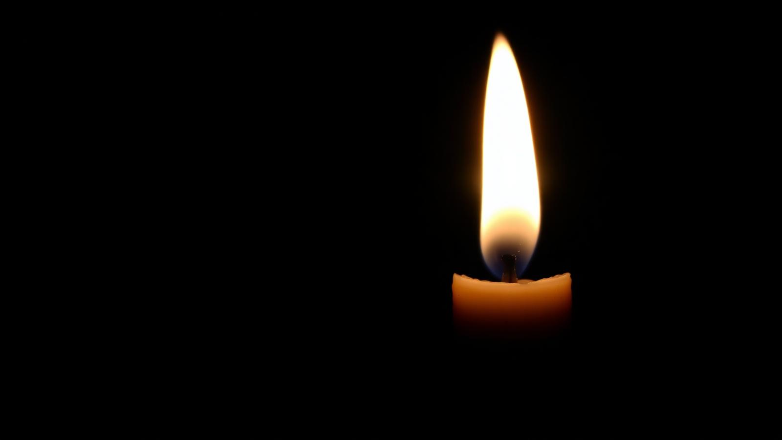 A single shadow forming beside an intense flame without extinguishing it